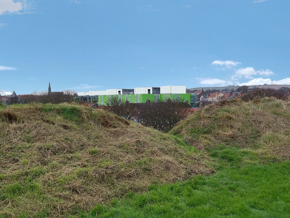 Hospital pods from Brass Bastion: light blue-grey against a blue sky